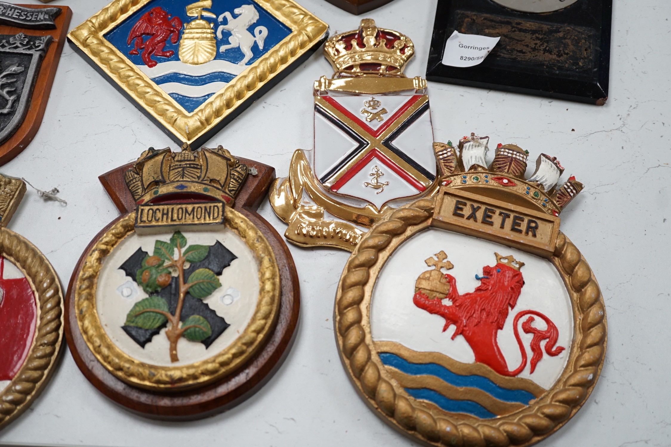 A collection of approximately twenty five plaster and other naval / military and Royal wall hanging plaques